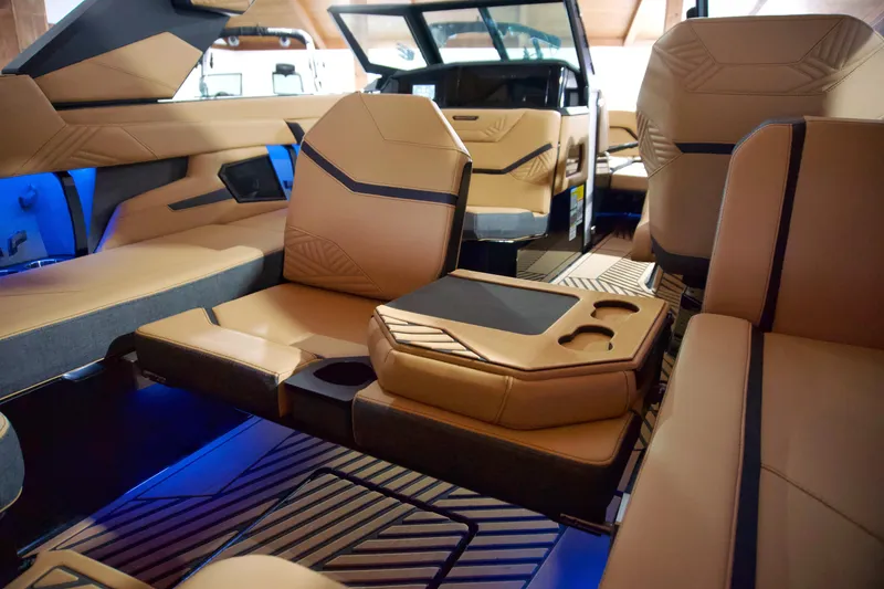 Slide: The Image of Luxurious interior of 2025 MasterCraft XStar 23 boat with tan leather seating and blue lighting. - 8