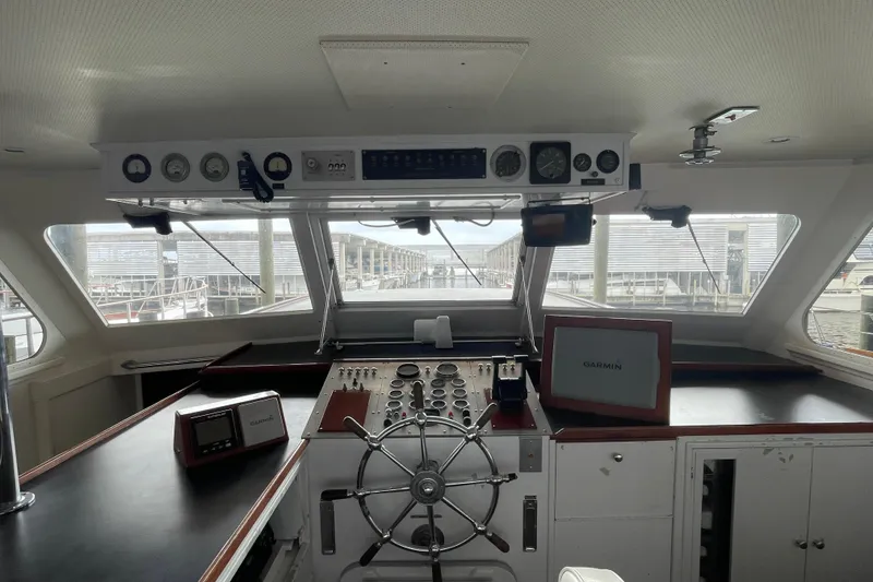 Slide: The Image of Interior view of a 1967 Huckins Offshore boat cockpit with navigation instruments. - 13