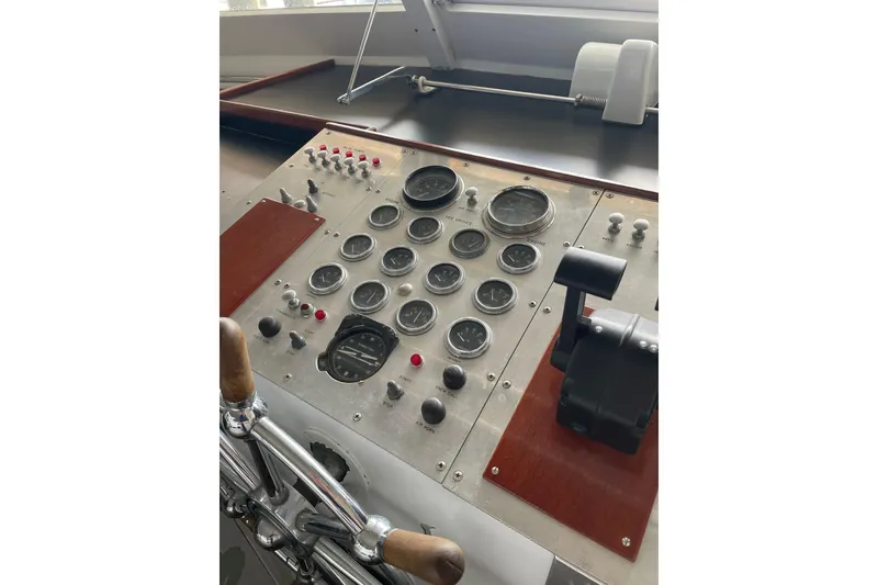 Slide: The Image of 1967 Huckins Offshore yacht control panel with gauges and levers. - 14