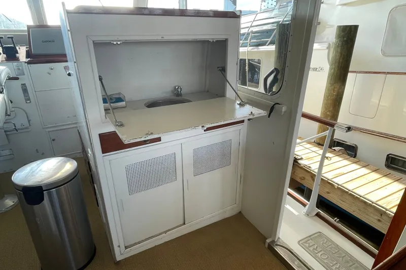 Slide: The Image of 1967 Huckins Offshore yacht interior with sink and storage cabinet. - 20
