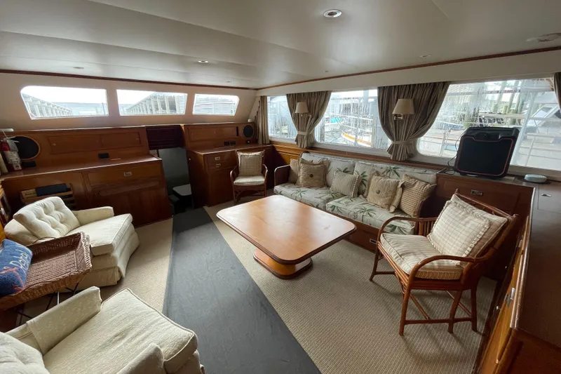 Slide: The Image of Interior of a 1967 Huckins Offshore yacht with cozy seating and wooden furnishings. - 21