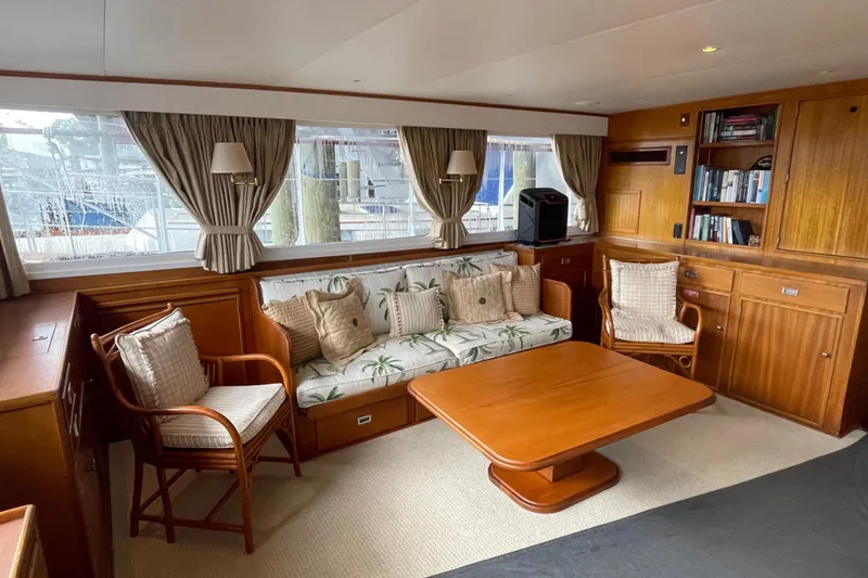 Slide: The Image of Interior of a 1967 Huckins Offshore yacht with elegant wood furnishings and cozy seating. - 24