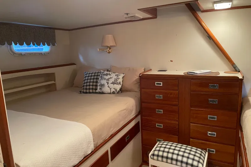 Slide: The Image of Cozy 1967 Huckins Offshore yacht cabin with bed, wooden drawers, and nautical decor. - 34