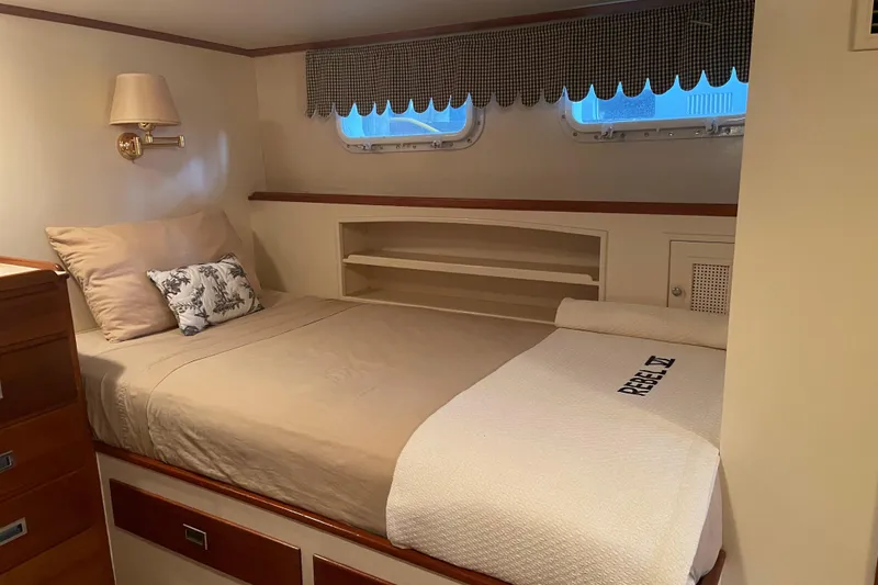 Slide: The Image of Cozy bedroom interior of a 1967 Huckins Offshore yacht with elegant bedding and wooden accents. - 35