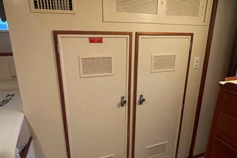 Slide: The Image of Interior of 1967 Huckins Offshore yacht with dual storage cabinets and wood trim. - 36