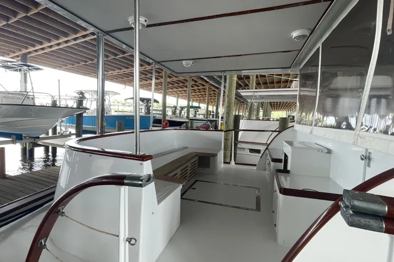 Slide: The Image of 1967 Huckins Offshore boat interior with sleek white seating and polished wood accents. - 7