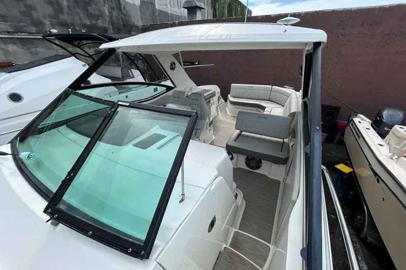Slide: The Image of 2020 Sea Ray Sundancer 320 boat interior with seating and windshield view. - 10
