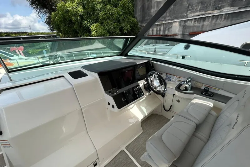 Slide: The Image of 2020 Sea Ray Sundancer 320 helm with modern controls and plush seating. - 11