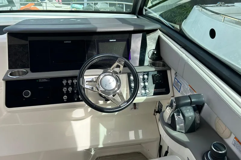 Slide: The Image of 2020 Sea Ray Sundancer 320 helm with modern controls and dual Simrad displays. - 12