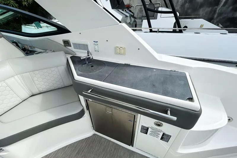 Slide: The Image of 2020 Sea Ray Sundancer 320 interior with kitchenette and seating area. - 17