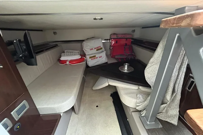 Slide: The Image of Interior cabin of 2020 Sea Ray Sundancer 320 with seating, life jackets, and safety equipment. - 20