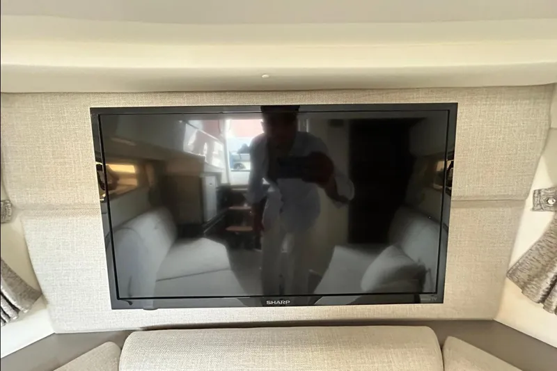 Slide: The Image of Interior of 2020 Sea Ray Sundancer 320 with wall-mounted Sharp TV. - 22