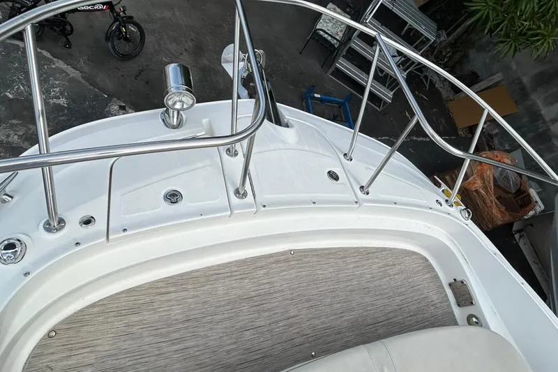 Slide: The Image of 2020 Sea Ray Sundancer 320 boat deck with stainless steel railings and textured flooring. - 25