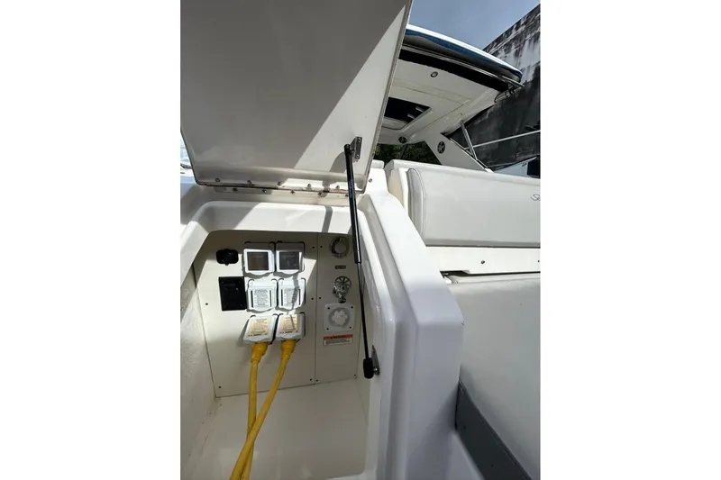 Slide: The Image of Electrical panel on a 2020 Sea Ray Sundancer 320 boat, featuring yellow power cables. - 26