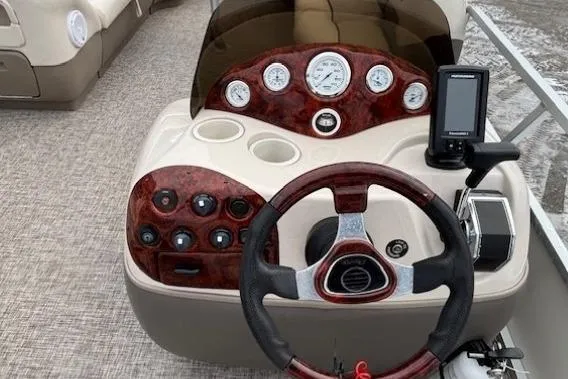 Slide: The Image of 2004 Sun Tracker Party Barge 22 Regency Edition dashboard with steering wheel and controls. - 14
