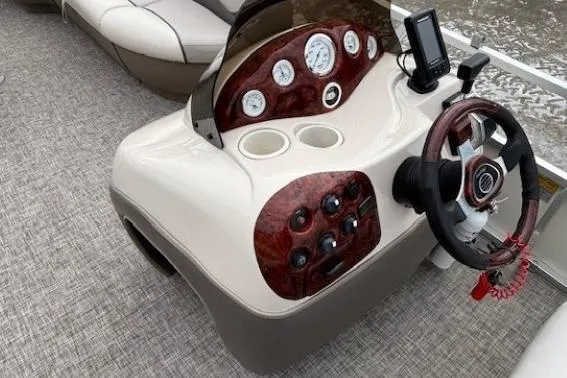 Slide: The Image of 2004 Sun Tracker Party Barge 22 Regency Edition dashboard with steering wheel and controls. - 15