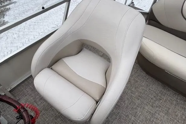 Slide: The Image of 2004 Sun Tracker Party Barge 22 Regency Edition boat seat, beige upholstery, on textured flooring. - 17