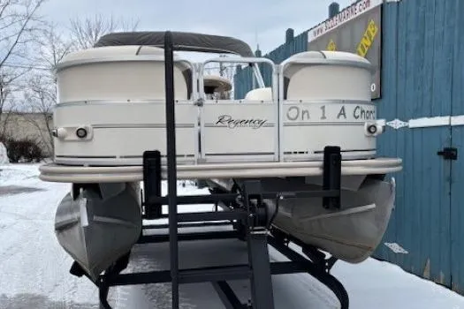 Slide: The Image of 2004 Sun Tracker Party Barge 22 Regency Edition pontoon boat on trailer in snowy setting. - 2