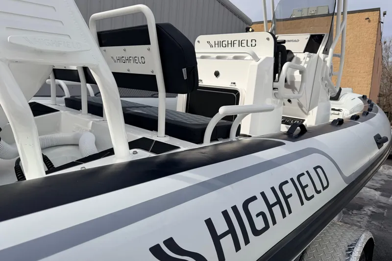 Slide: The Image of 2025 Highfield Sport 560 boat, white with black accents, featuring modern seating and design. - 14