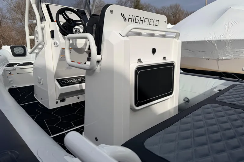 Slide: The Image of 2025 Highfield Sport 560 boat interior with steering console and seating. - 15
