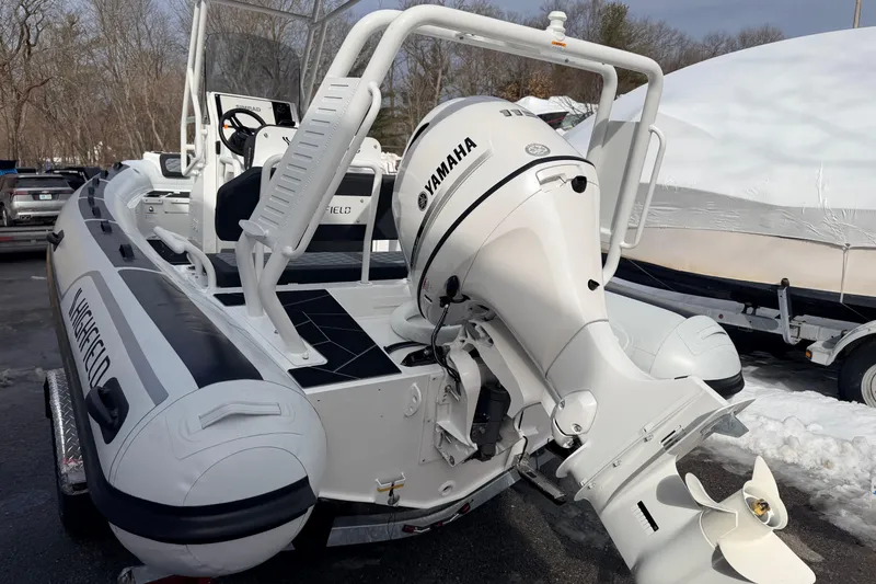 Slide: The Image of 2025 Highfield Sport 560 boat with Yamaha outboard motor, parked outdoors. - 9