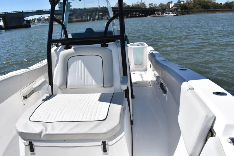 Slide: The Image of 2021 Sea Fox 268 Commander boat interior with seating, on a sunny day by the water. - 24