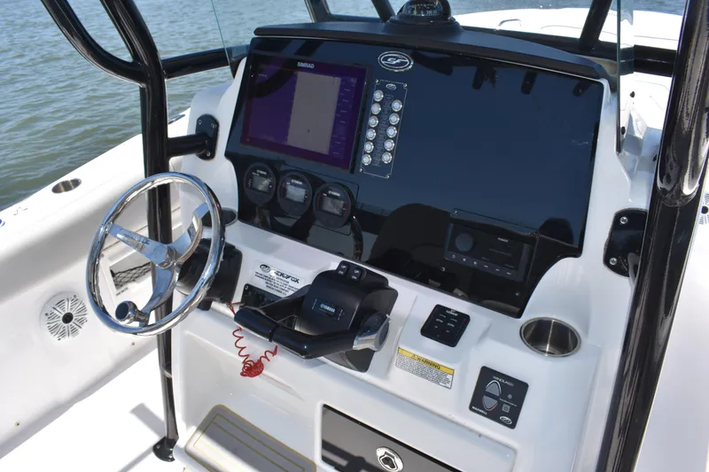 Slide: The Image of 2021 Sea Fox 268 Commander boat dashboard with steering wheel and navigation controls. - 40