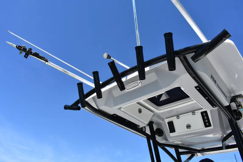 Slide: The Image of 2021 Sea Fox 268 Commander boat with fishing rod holders against clear blue sky. - 55