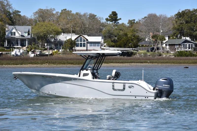 Slide: The Image of 2021 Sea Fox 268 Commander boat cruising on a calm river near waterfront homes. - 7