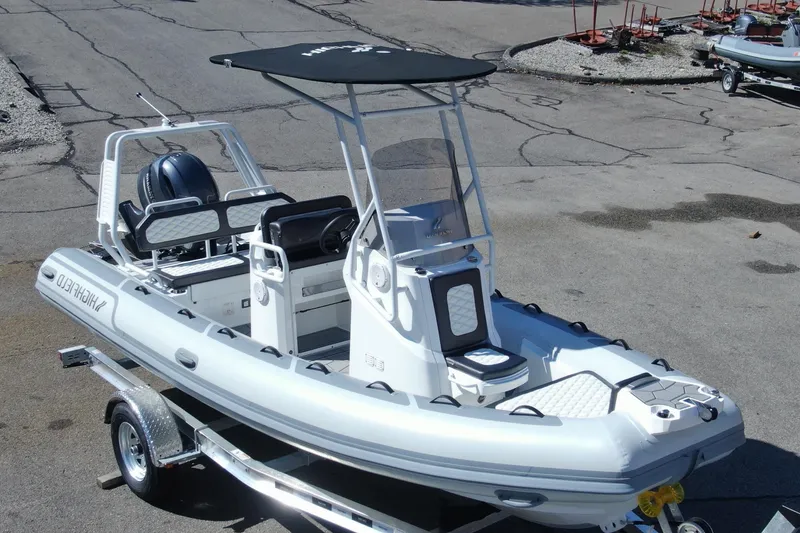 The Image of 2025 Sport 560 inflatable boat on trailer, featuring sleek design and modern equipment. - 0