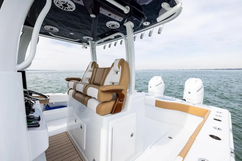 Slide: The Image of 2026 Freeman 32 boat interior with luxurious seating and dual Mercury engines on open water. - 10