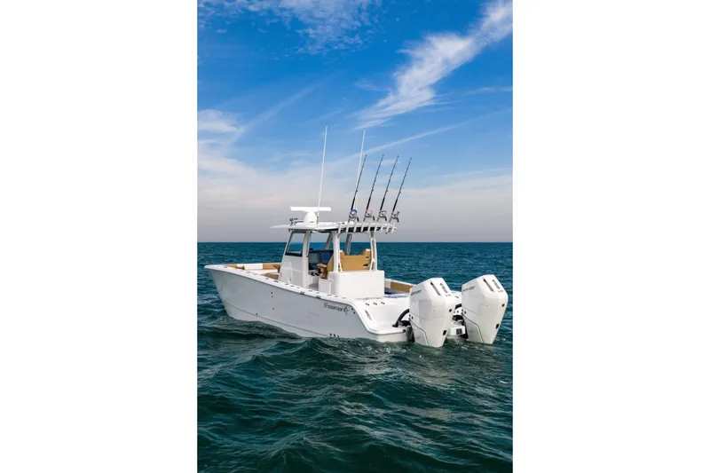 Slide: The Image of 2026 Freeman 32 boat on open water with dual engines and fishing rods. - 5