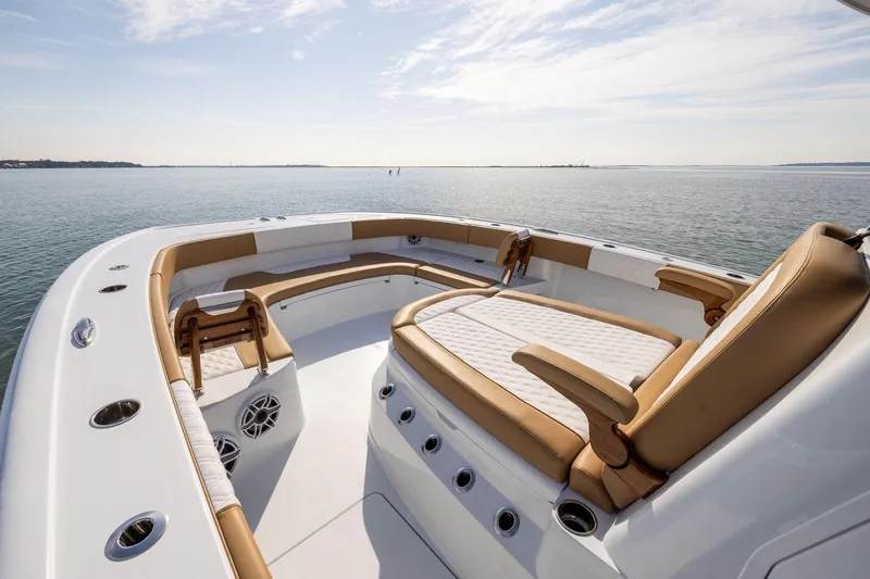 Slide: The Image of Luxurious 2026 Freeman 32 boat interior with tan seating on calm water. - 7