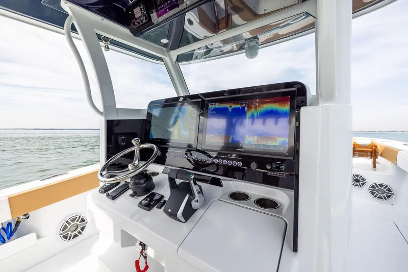 Slide: The Image of Helm of 2026 Freeman 32 boat with advanced navigation system and steering wheel. - 12