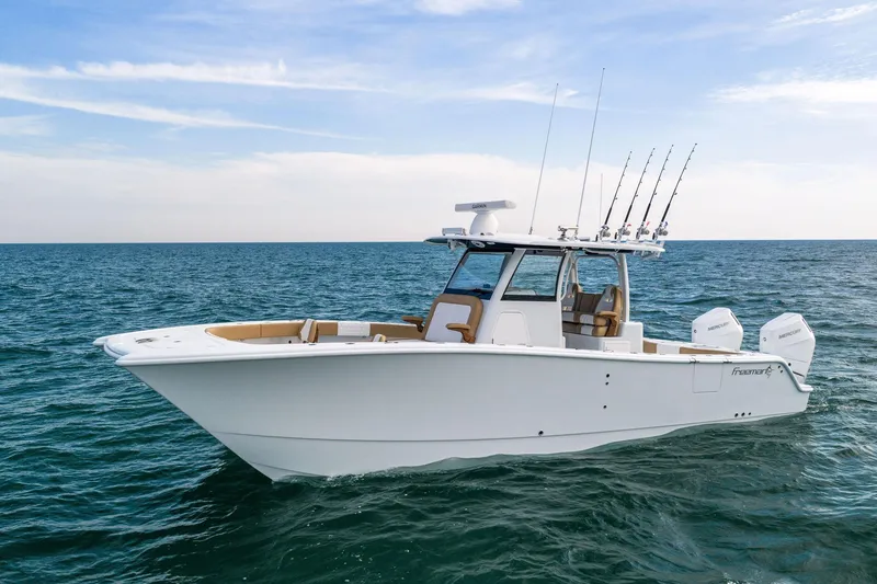 Slide: The Image of 2026 Freeman 32 boat on open sea with fishing rods and twin engines. - 4