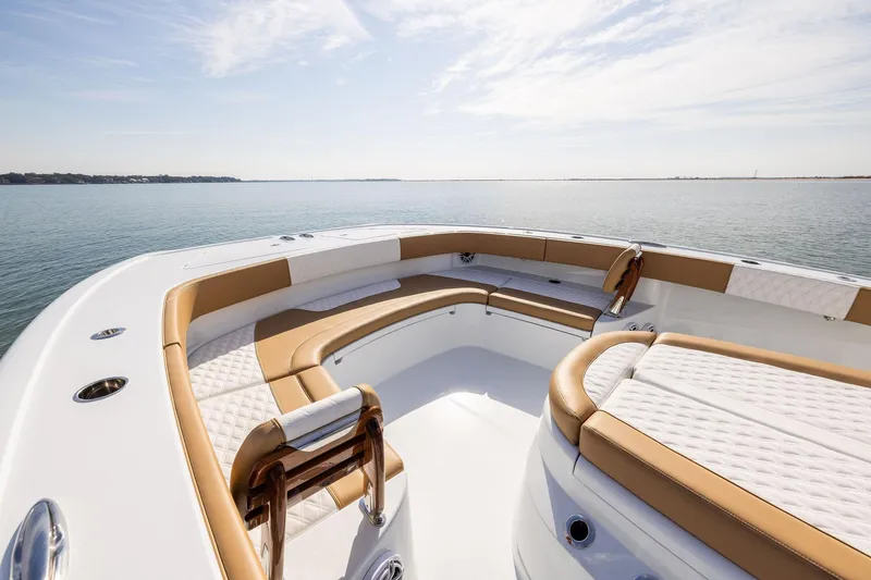 Slide: The Image of Luxurious 2026 Freeman 32 boat interior with tan and white seating on calm water. - 8
