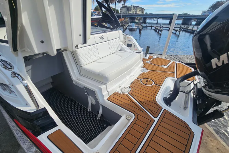 Slide: The Image of 2017 Monterey M-45 boat with teak flooring and white seating at a dockside location. - 5