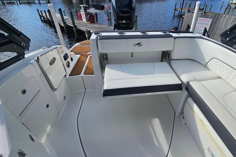 Slide: The Image of 2017 Monterey M-45 boat interior with white seating and wooden deck accents. - 7