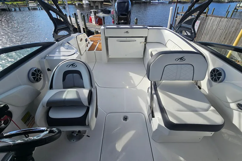 Slide: The Image of 2017 Monterey M-45 boat interior with white seating and waterfront view. - 8