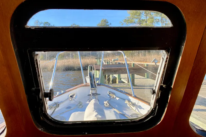 Slide: The Image of View from 1979 Outer Reef 26/31 boat cabin window, dockside with clear blue sky. - 100