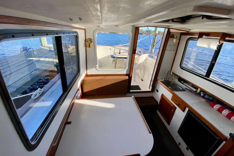 Slide: The Image of Interior of a 1979 Outer Reef 26/31 boat with dining area and kitchenette. - 104
