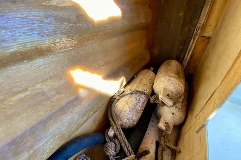 Slide: The Image of Old boat fenders and ropes in a wooden compartment, Outer Reef 26/31, 1979. - 113