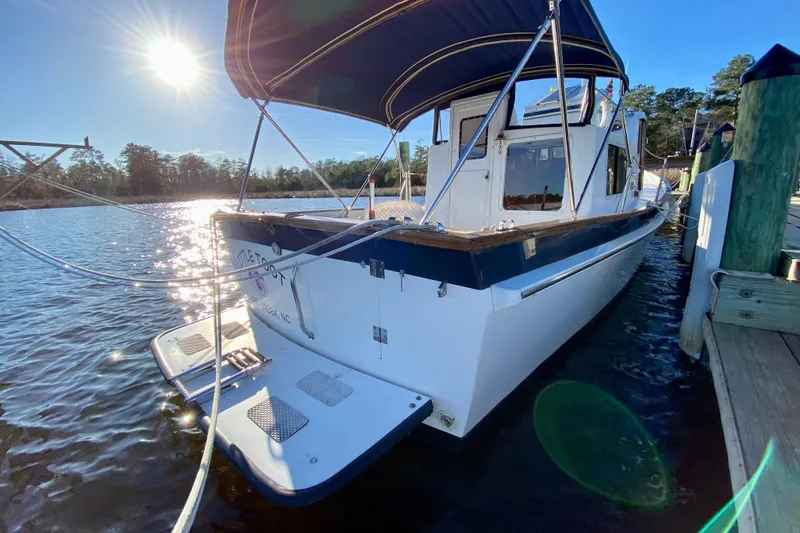 Slide: The Image of 1979 Outer Reef 26/31 boat docked under sunny blue sky. - 114