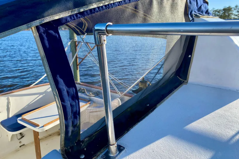 Slide: The Image of 1979 Outer Reef 26/31 boat deck with railing and canopy, overlooking water. - 117