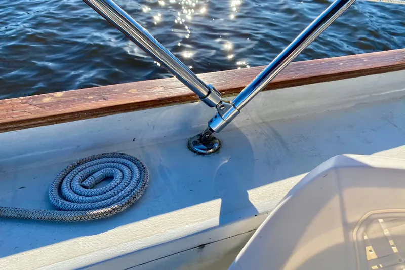 Slide: The Image of Coiled rope and metal railing on 1979 Outer Reef 26/31 boat deck by water. - 16