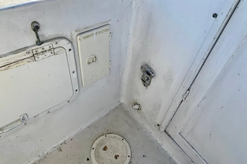 Slide: The Image of Interior corner of a 1979 Outer Reef 26/31 boat showing access panels and fixtures. - 18