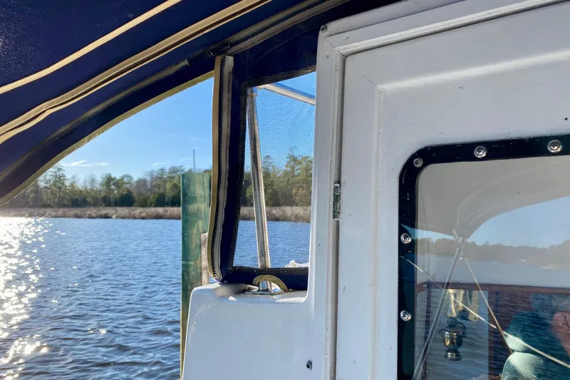 Slide: The Image of View from a 1979 Outer Reef 26/31 boat, showing water and shoreline. - 19