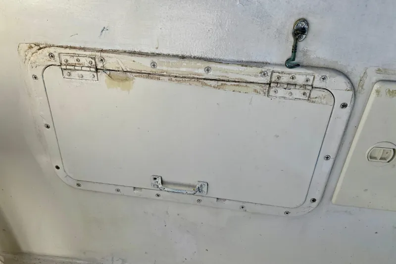 Slide: The Image of Hinged access panel on 1979 Outer Reef 26/31 boat, showing wear and rust. - 20
