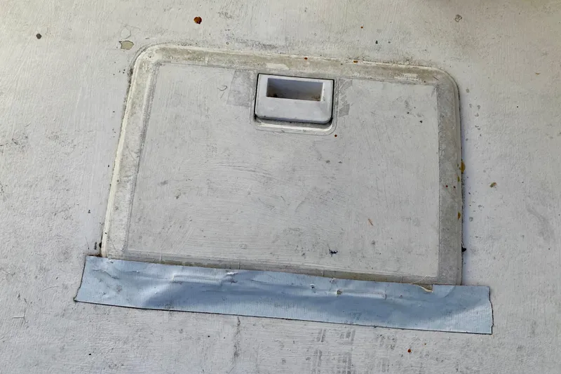 Slide: The Image of Hatch cover on 1979 Outer Reef 26/31 boat deck with tape repair. - 22