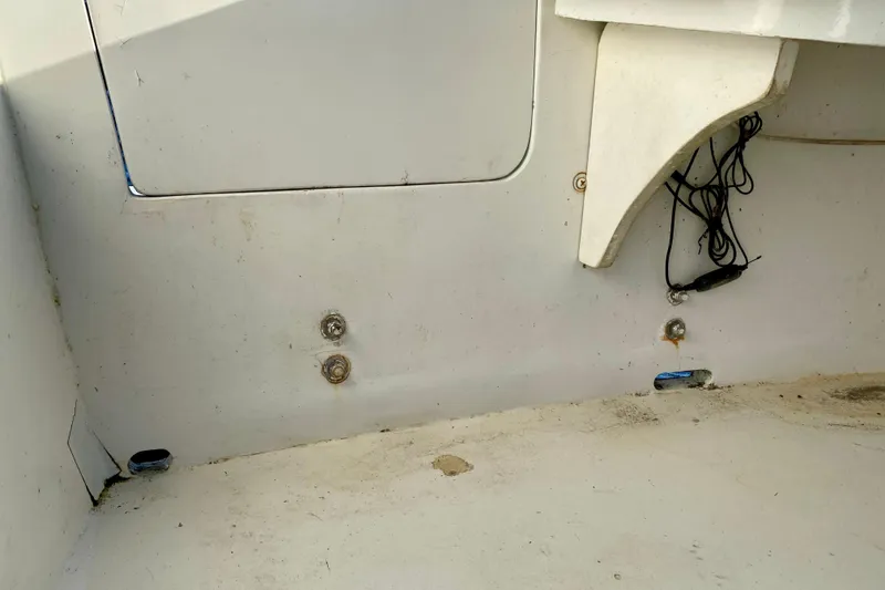 Slide: The Image of Interior of a 1979 Outer Reef 26/31 boat showing storage compartment and wiring. - 24